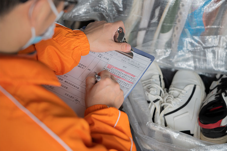 inspector taking a list of the used shoe pair's details