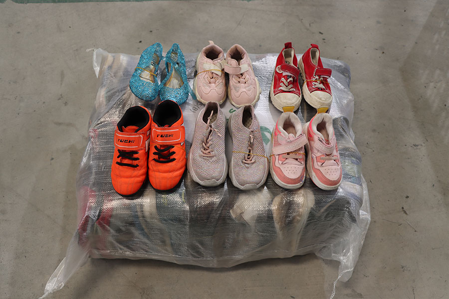 colorful assortment of used children's shoes