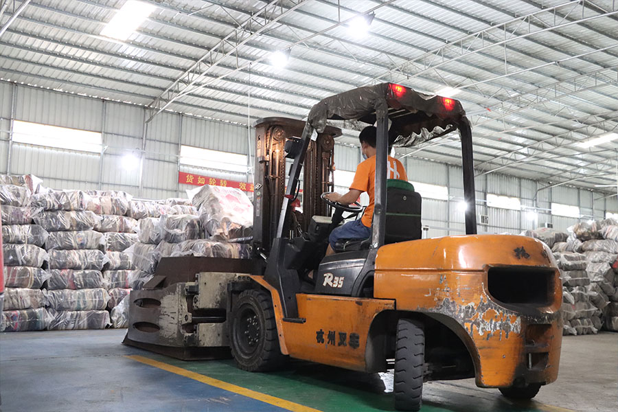 forklift operator moving the sorted used shoes to another location